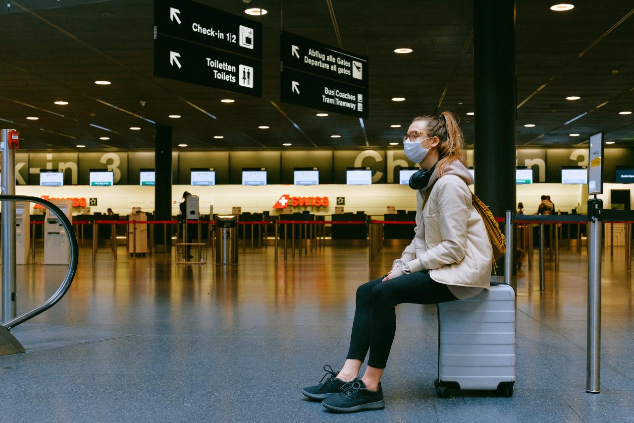 woman traveller with mask in airport